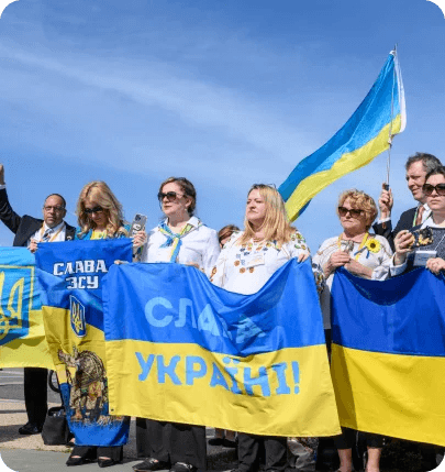 Demonstrators with Ukrainian flags reading 'Slava Ukraini'